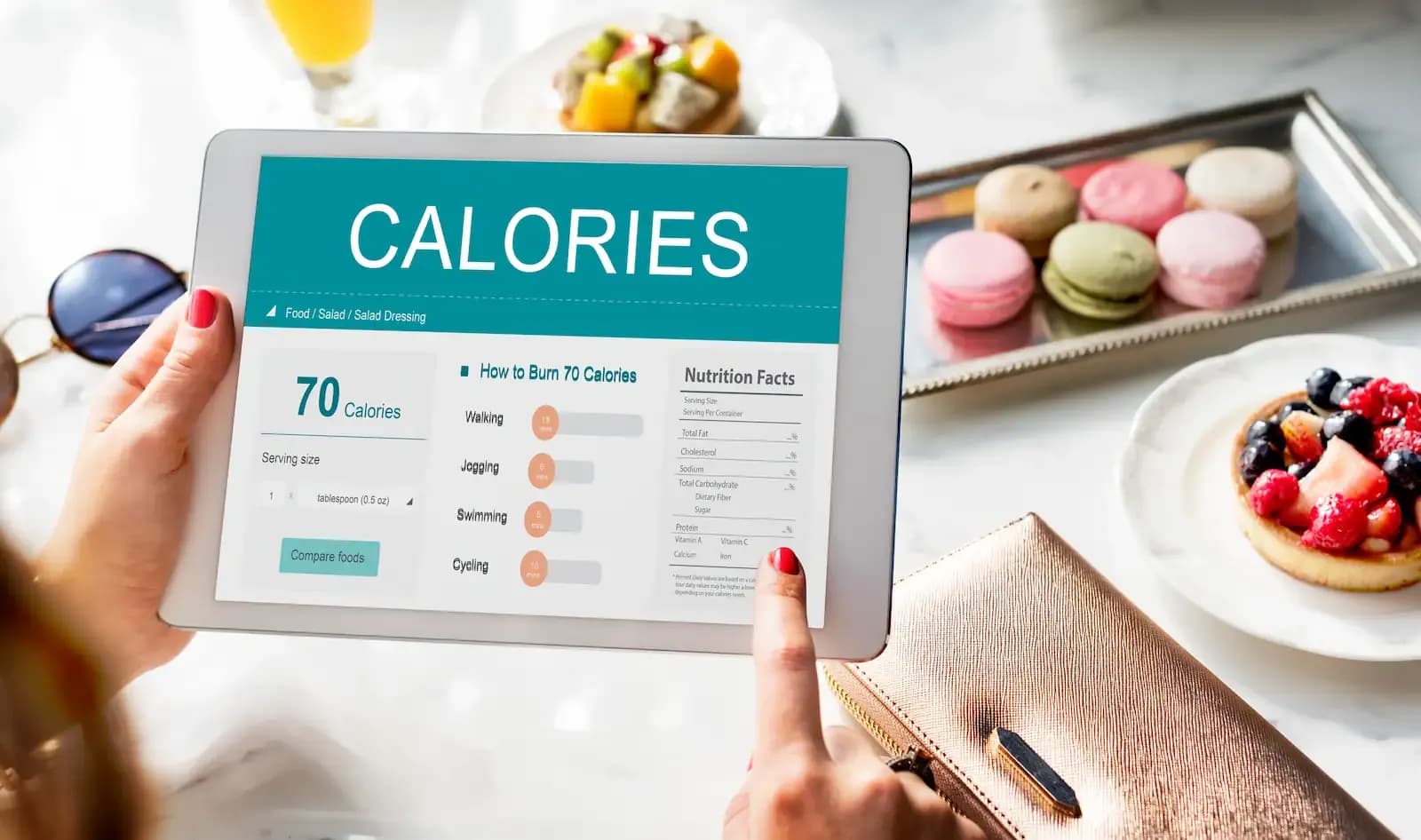 A woman using a tablet to calculate how many calories she will eat